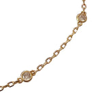 dainty gold chain necklace with five circular clear stones