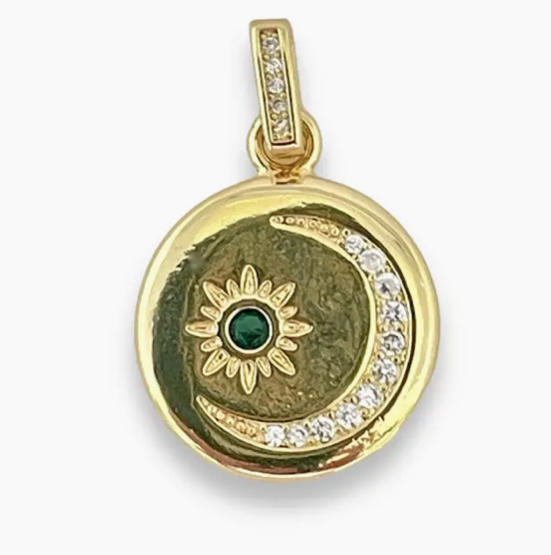 Gold-plated round charm with crystal-studded crescent moon and starburst design featuring a green center stone.