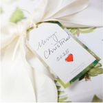 Gift wrapped in green paper with a white ribbon and a 'Merry Christmas 2025' tag.