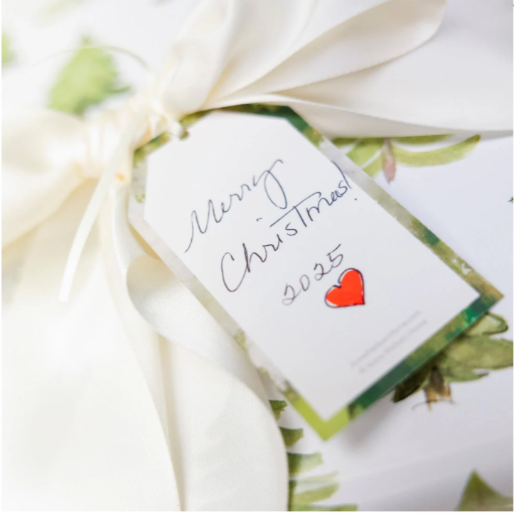 Gift wrapped in green paper with a white ribbon and a 'Merry Christmas 2025' tag.