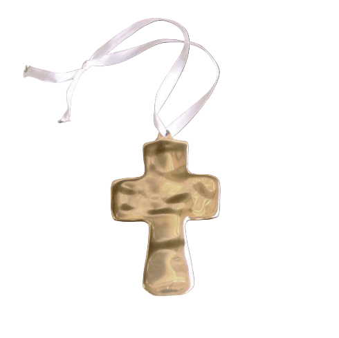 Gold cross pendant on a white ribbon against a white background