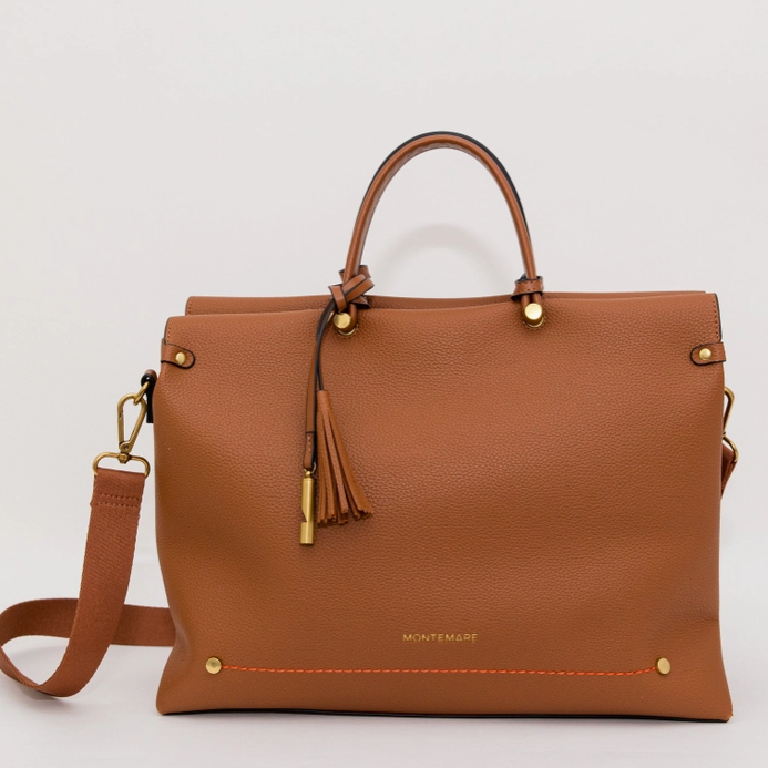 Brown leather handbag with gold accents on a light gray background