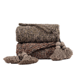 Knitted blanket with tassels on a white background
