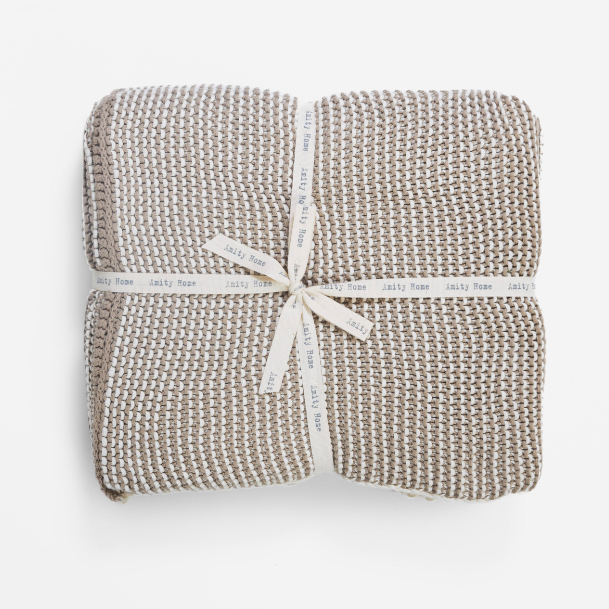Woven blanket with a ribbon on a white background