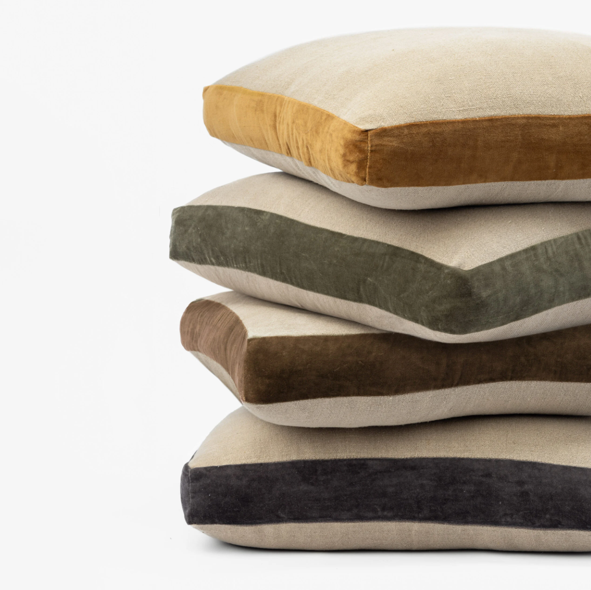 Stack of four pillows with different color combinations on a white background