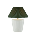 Table lamp with a green pleated shade and white base on a white background