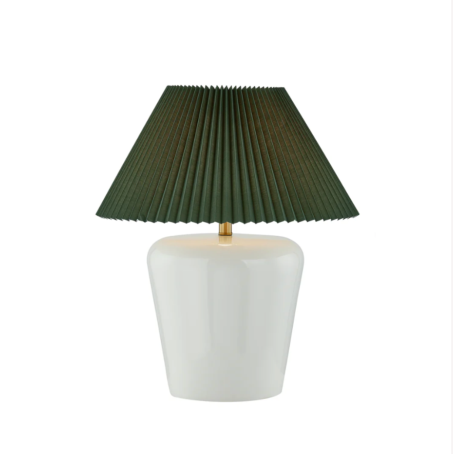 Table lamp with a green pleated shade and white base on a white background