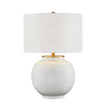 Table lamp with a white textured base and gold accents on a white background