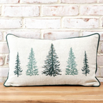 Decorative pillow with tree pattern on a wooden surface and brick wall background