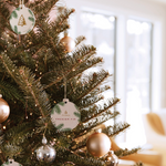 Decorated Christmas tree with ornaments and lights in a home setting