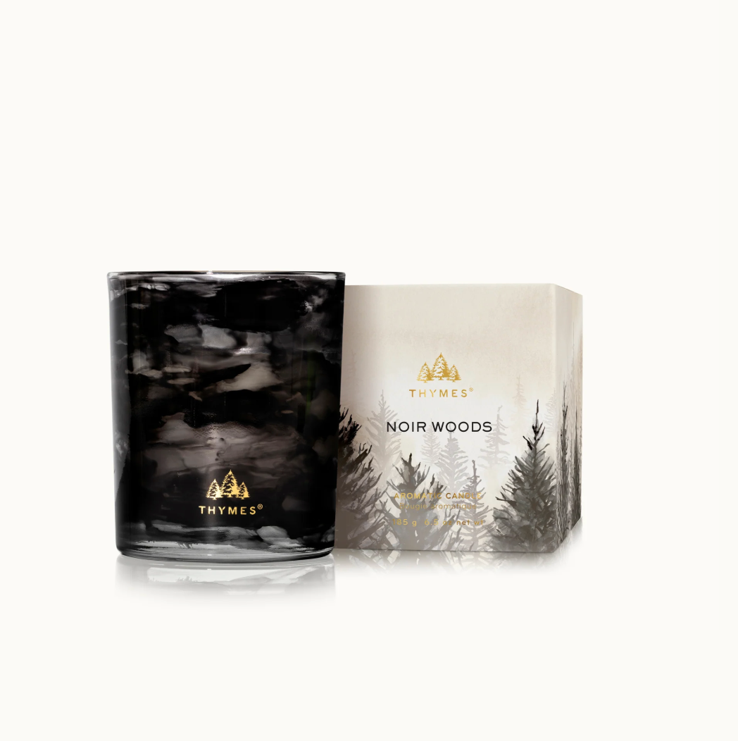 Thymes Noir Woods candle and packaging on a white background