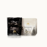 Thymes Noir Woods candle and packaging on a white background