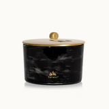 Black marbled candle jar with gold lid on a white background, featuring the Thymes logo.