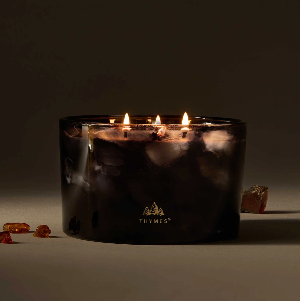 Thymes candle with three flames on a dark background