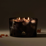 Thymes candle with three flames on a dark background