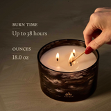 Candle being lit with text about burn time and size, featuring the Thymes brand.