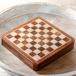 Wooden chess board with checkered pattern on a wooden surface