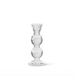 Clear glass taper candle holder on a white background