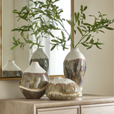styled set of three ceramic vases in earthy brown and ivory tones with organic drip glaze, in varying sizes, on a wooden surface with a neutral background