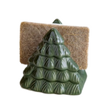 Green ceramic tree-shaped soap holder with a brown sponge on a white background