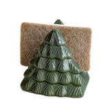Green ceramic tree-shaped soap holder with a brown sponge on a white background