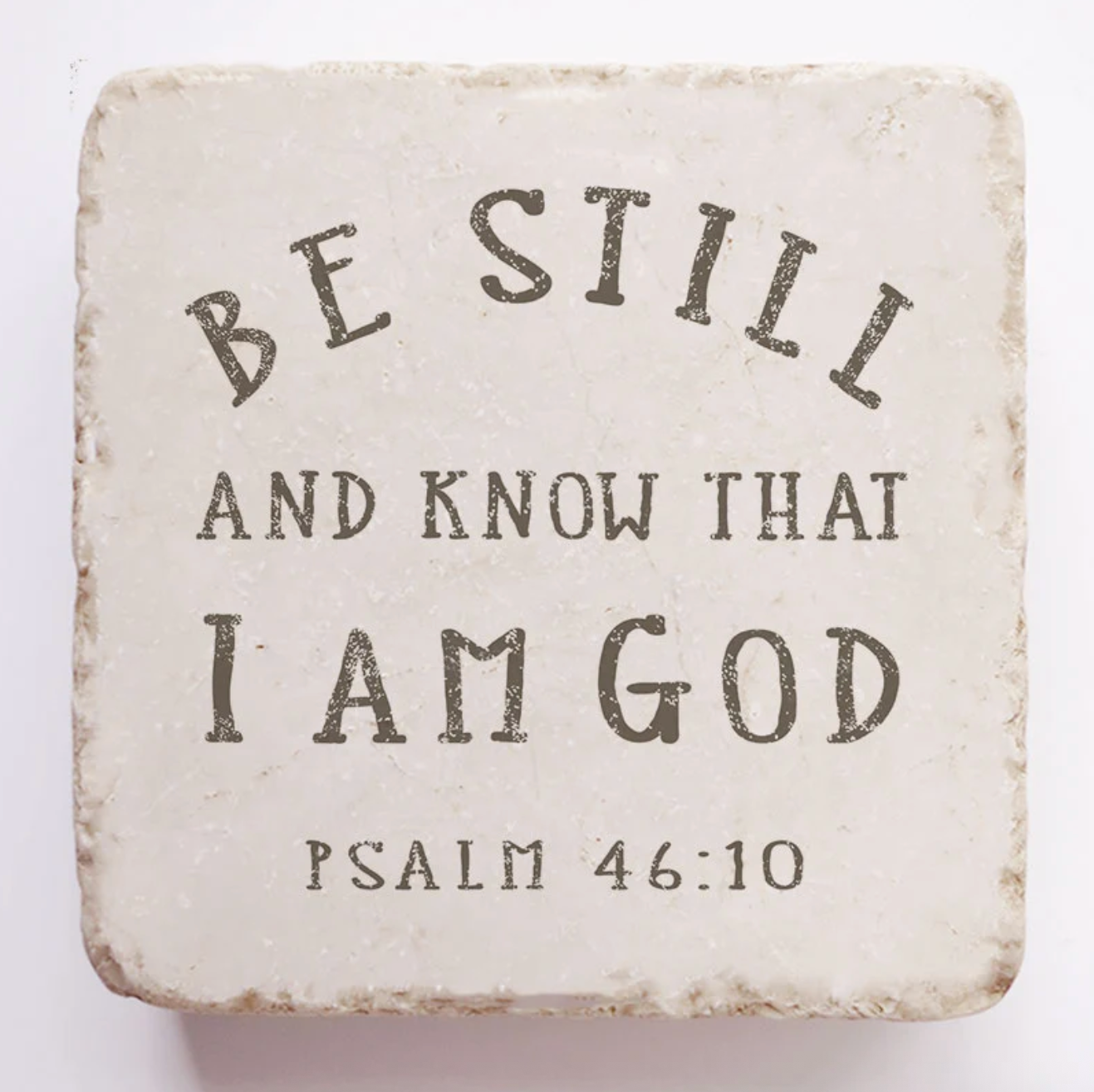 Square stone coaster with 'Be Still and Know That I Am God' text on a white background