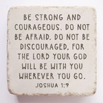 Decorative stone with motivational quote 'Be strong and courageous. Do not be afraid.' on a white background