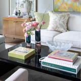 Living room with a coffee table, books, and decorative items.
