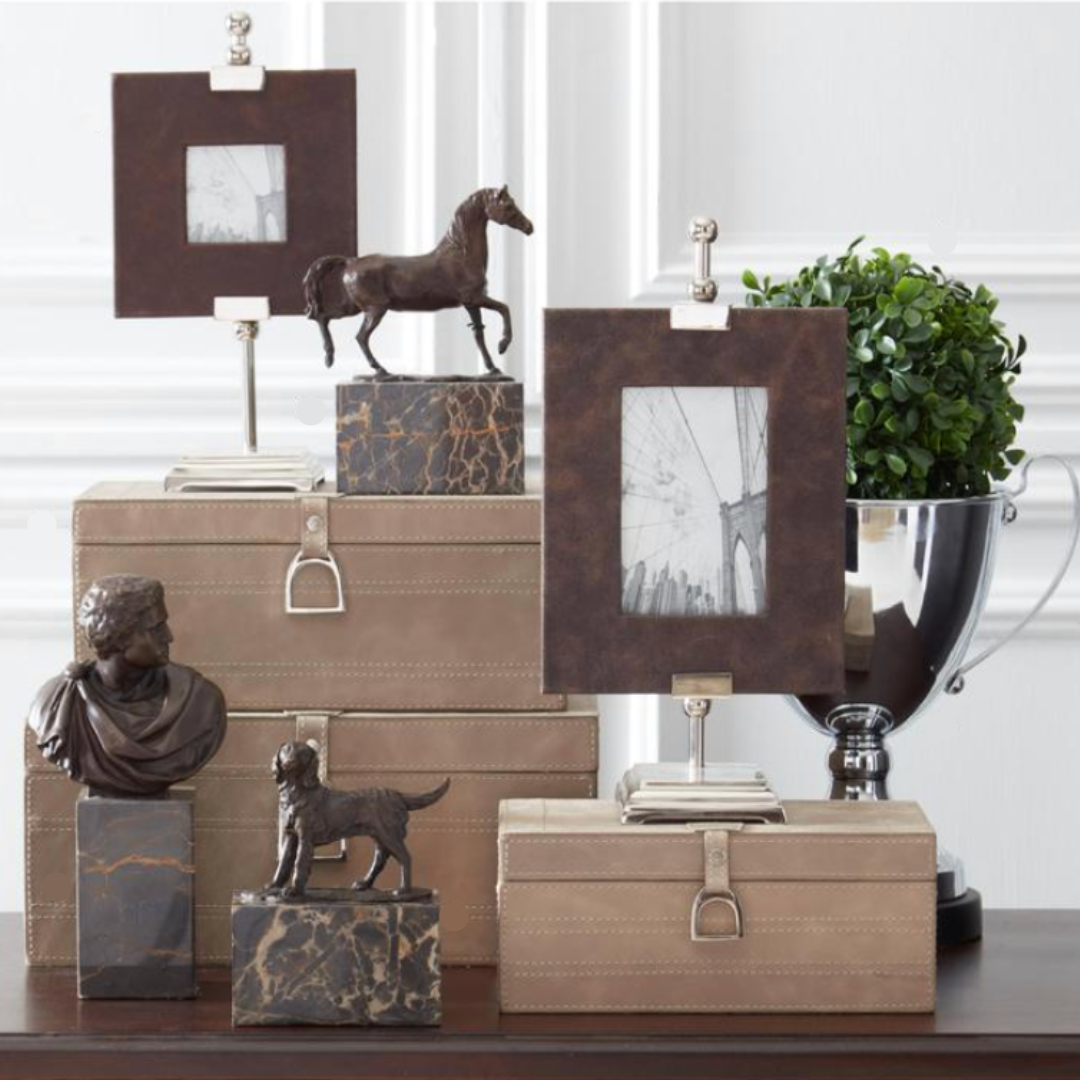 Decorative items including photo frames, sculptures, and boxes on a table.
