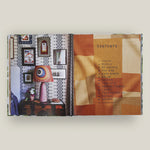 Open book with interior design-themed pages on a white background
