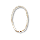 Pearl necklace with a gold clasp on a white background