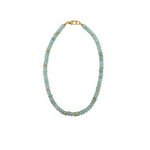 Necklace with light blue beads and gold accents on a white background