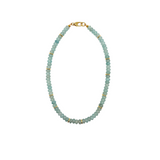 Necklace with light blue beads and gold accents on a white background