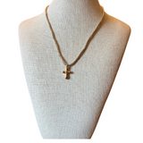 Necklace with a cross pendant on a mannequin bust against a white background