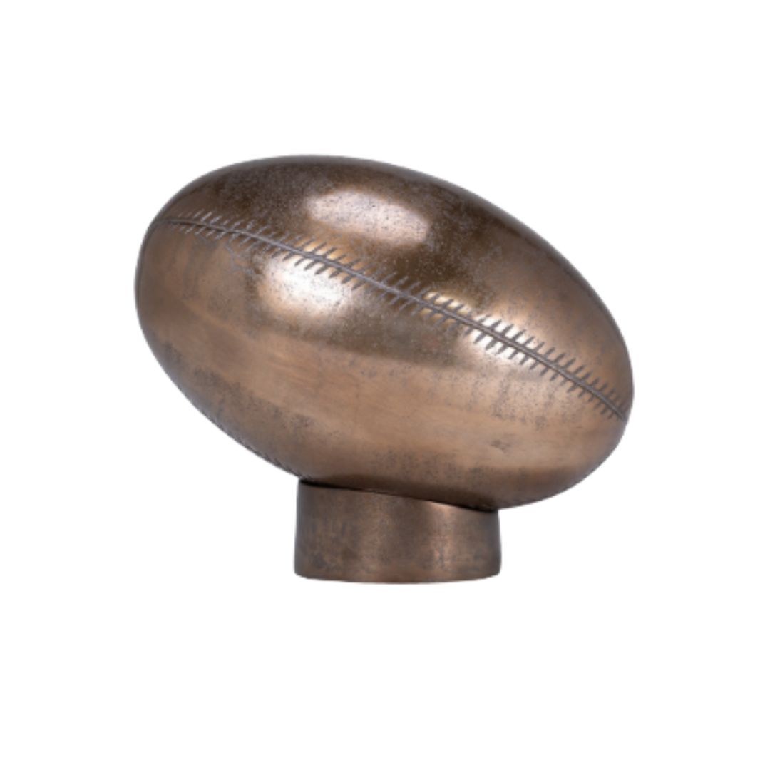 Bronze-colored object resembling a rugby ball on a white background