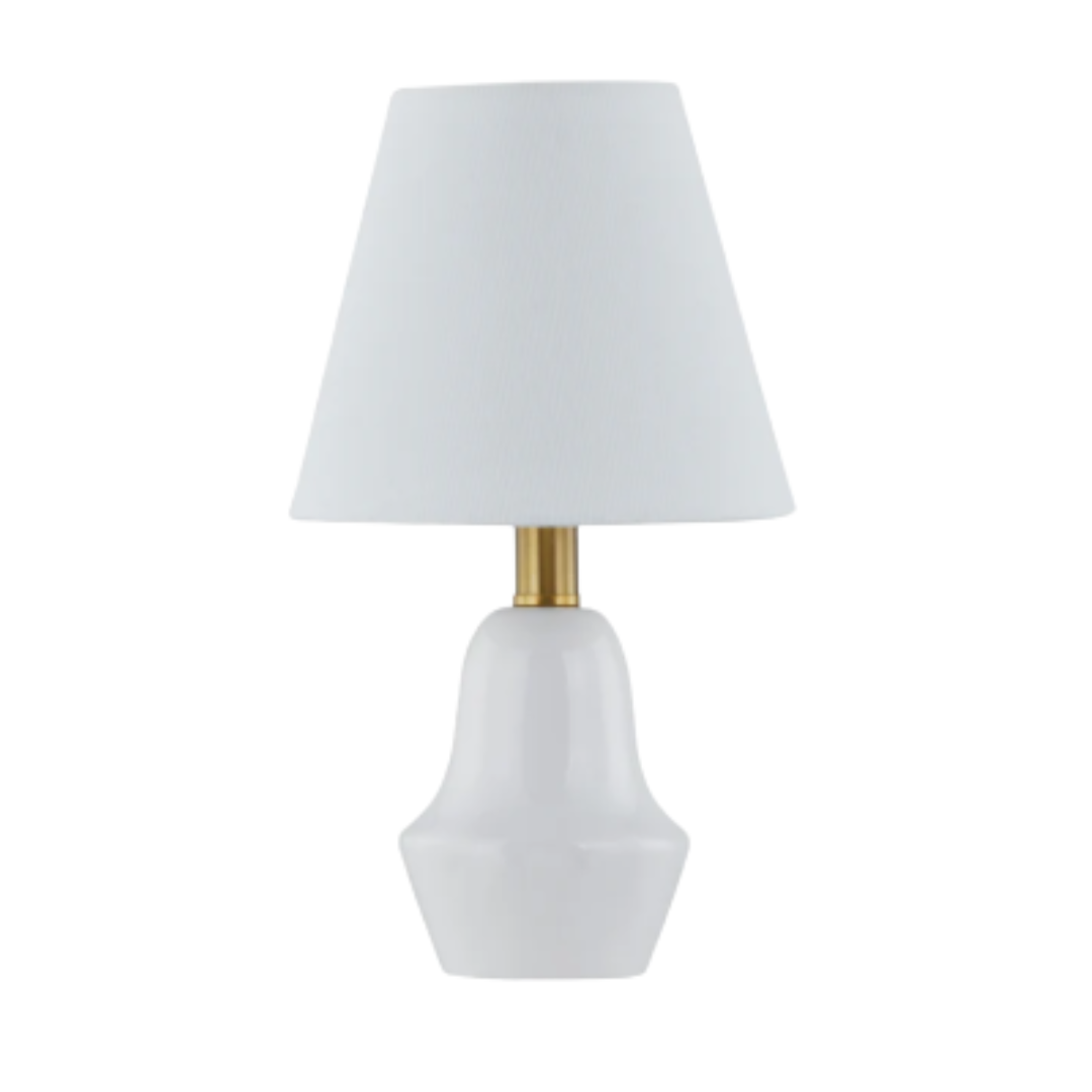 Table lamp with a white shade and gold accent on a white background