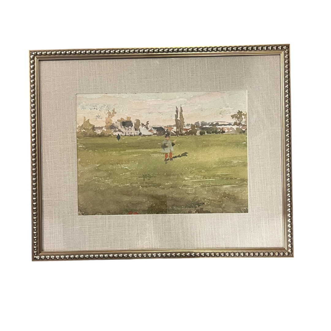 Framed artwork of a person playing golf on a grassy field with buildings in the background.