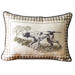 Decorative pillow with a checkered border featuring an illustration of a dog in a natural setting.