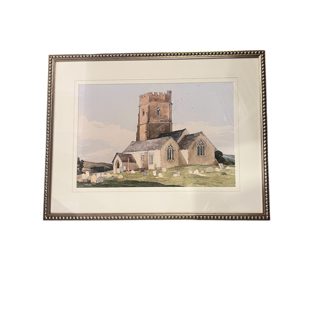 Framed artwork of a church with a white border