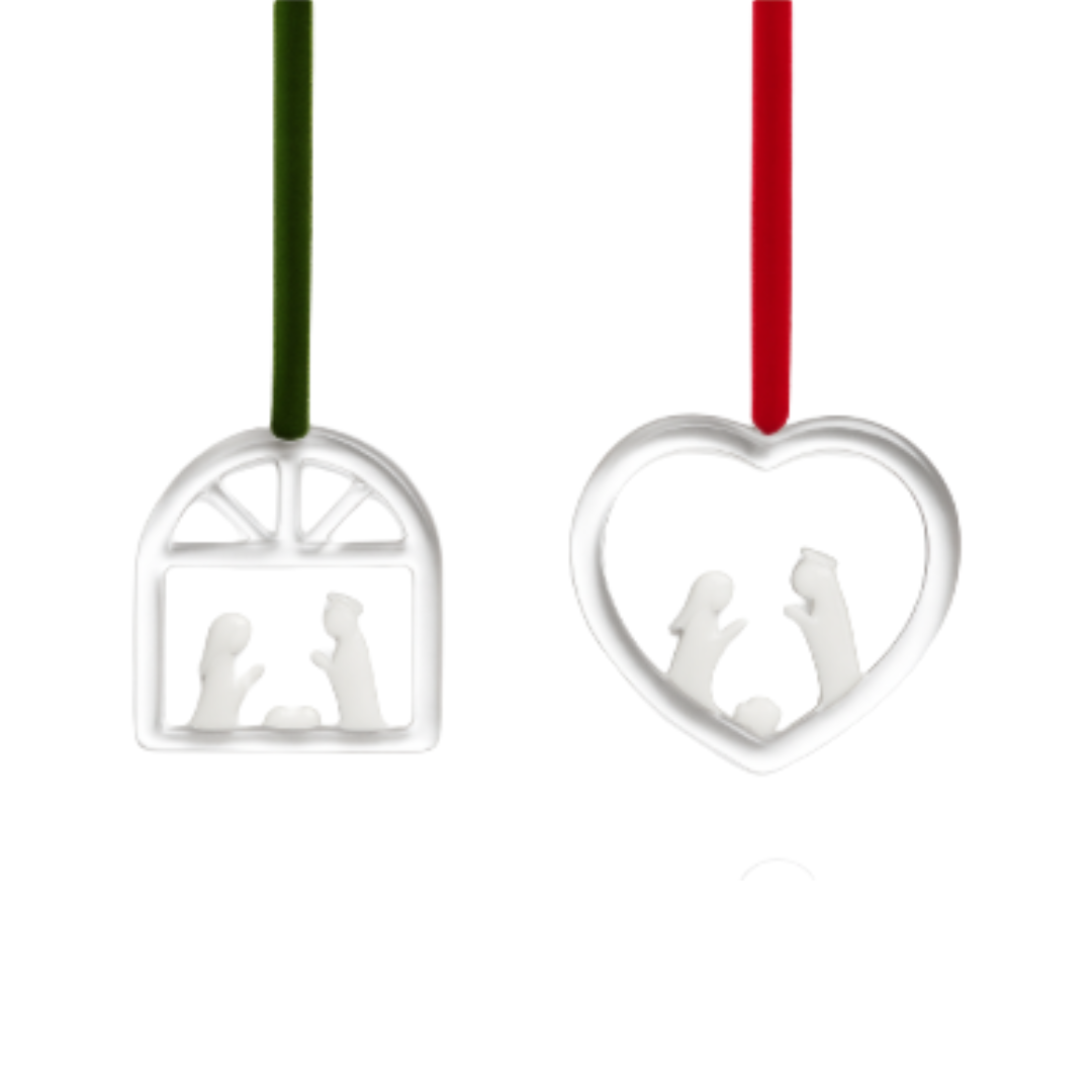 Two silver Christmas ornaments with cut-out figures on a white background