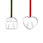 Two silver Christmas ornaments with cut-out figures on a white background