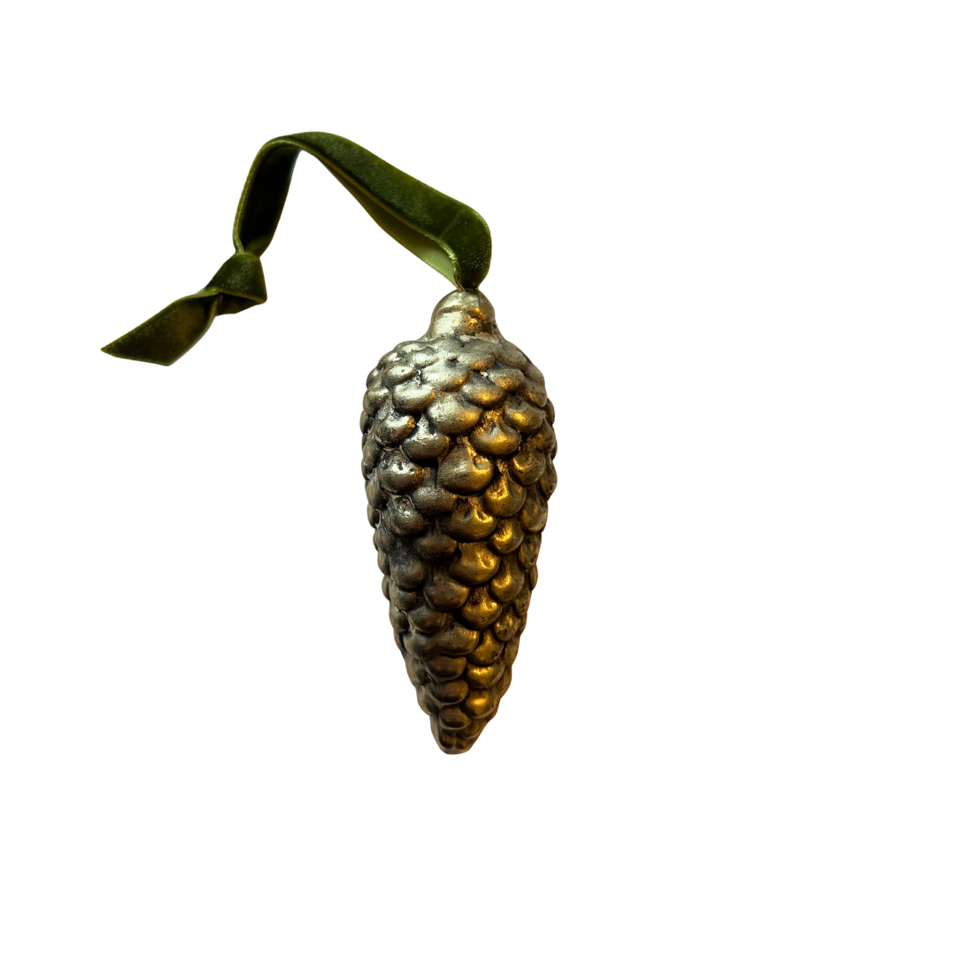Decorative pine cone ornament with a green ribbon on a white background