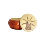 Copper pumpkin-shaped candle with a gold lid on a white background