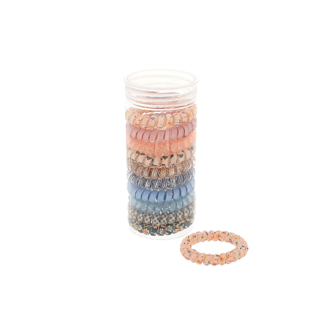 Set of colorful hair ties in a clear container on a white background