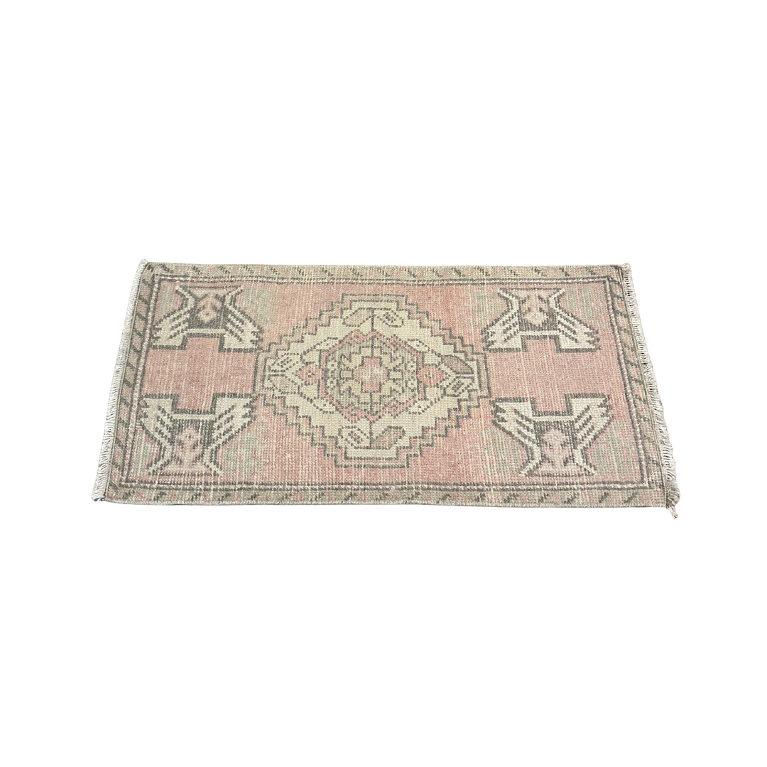 Small rectangular rug with geometric pattern on a white background