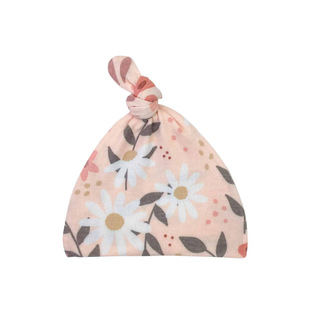 Floral patterned baby hat on a white background