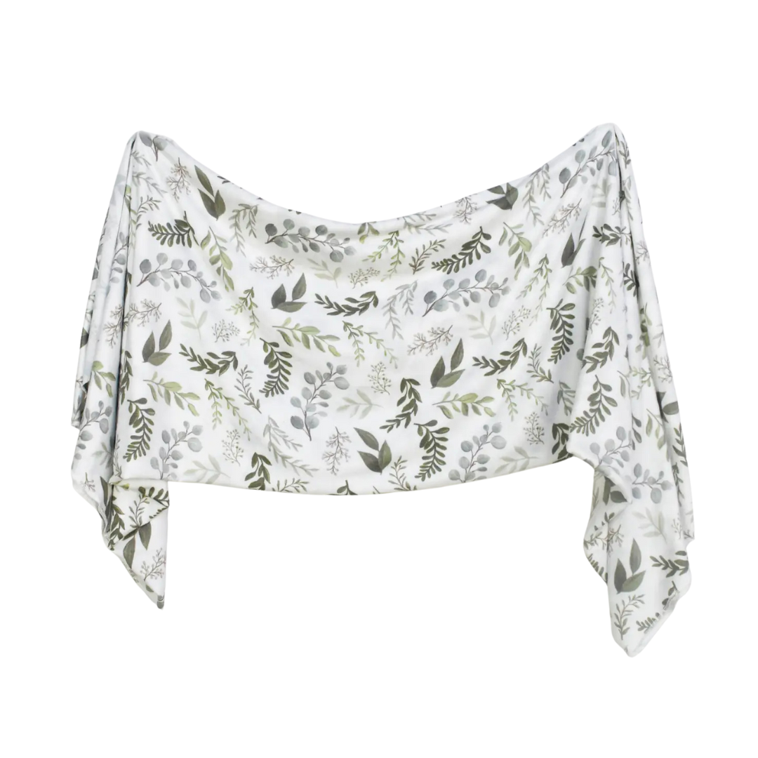 White fabric with green leaf pattern on a white background