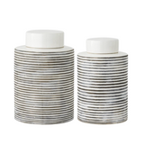 Two striped ceramic jars with white lids on a white background