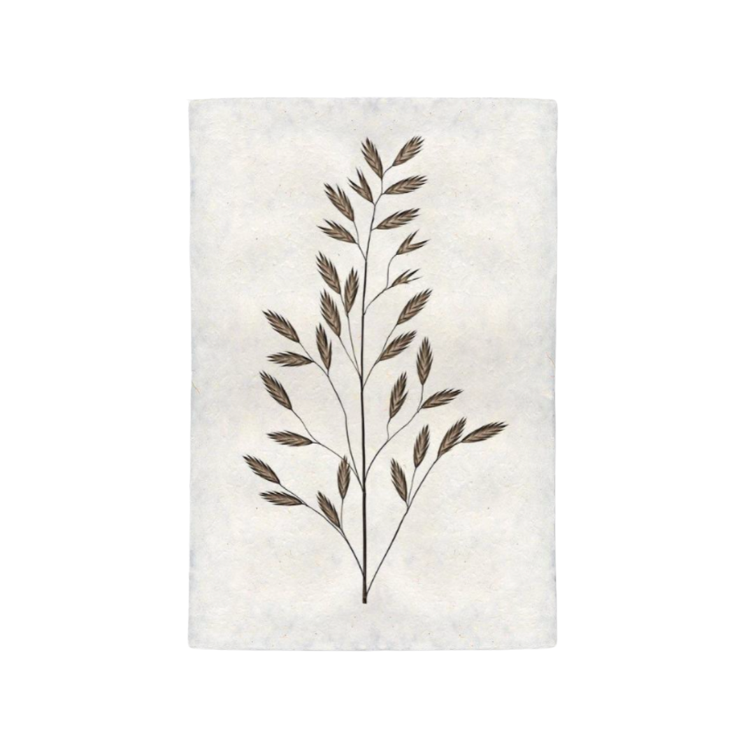 Decorative wall art with a leaf design on a textured white background