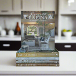 Stack of books titled 'Patina Homes & Gardens' on a white background